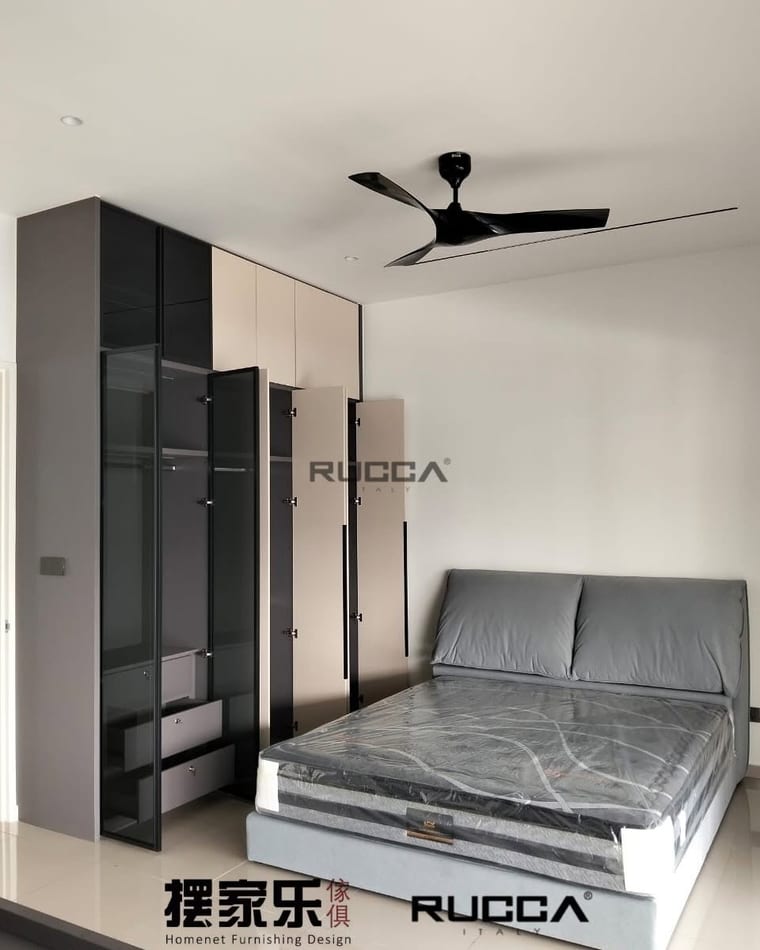 A bedroom with a bed frame and mattress beside a fitted two-tone wardrobe.