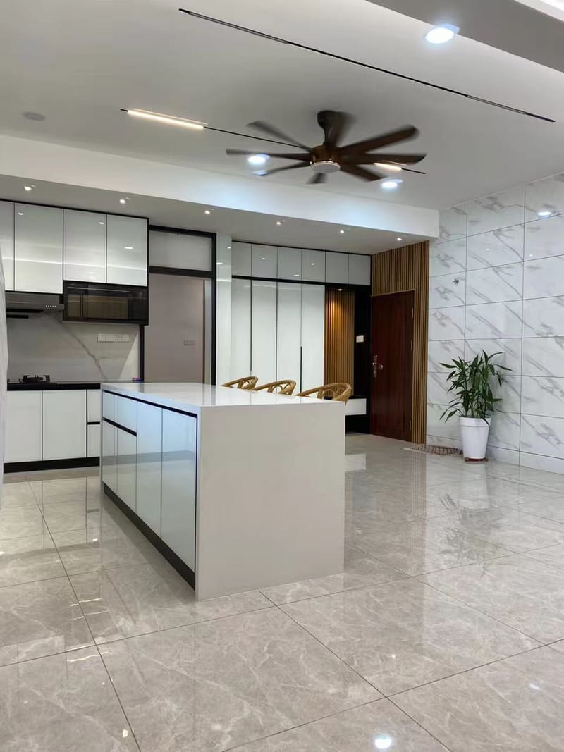 A white gloss kitchen with a stone-topped island.