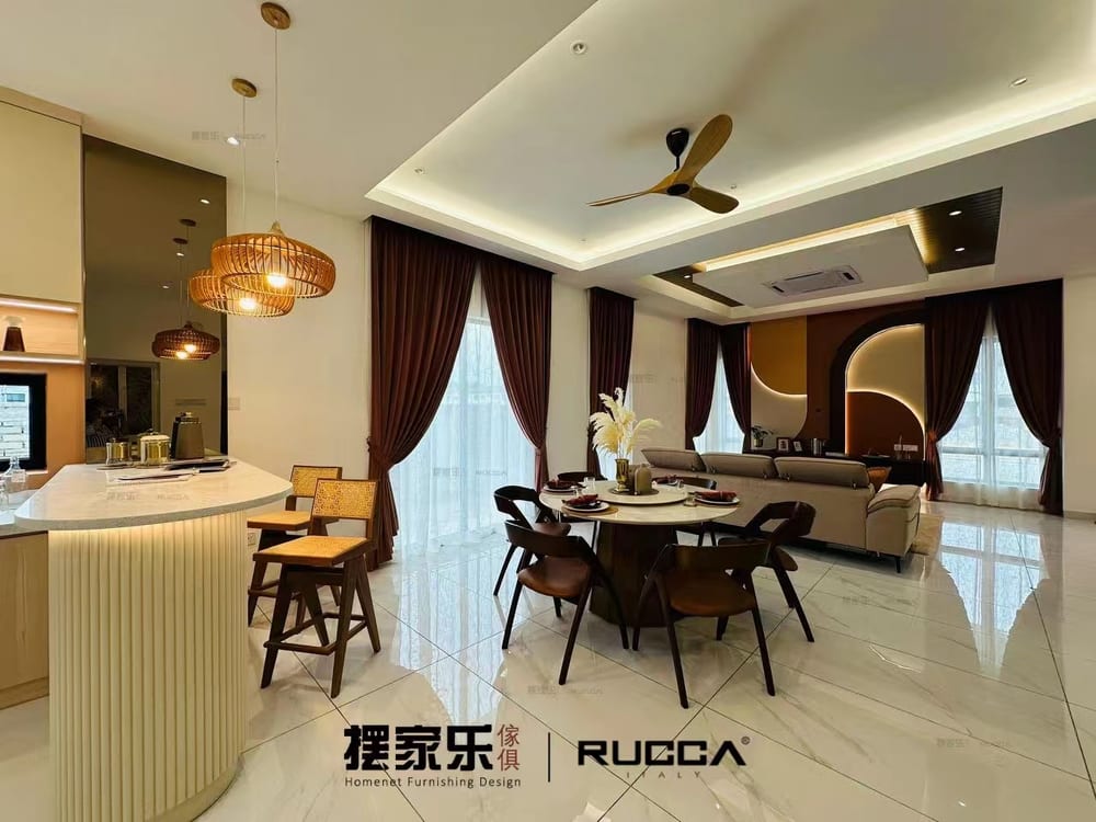 An open-plan living and dining room with a curved bar counter, pendant cluster and dining set.
