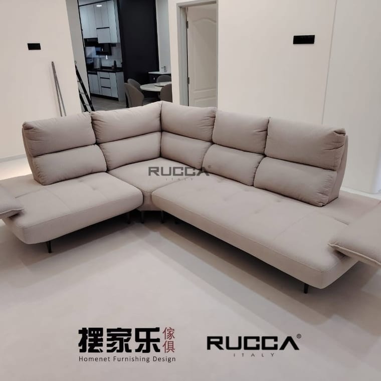 A cream L-shaped fabric sofa with adjustable headrests in a finished living room.